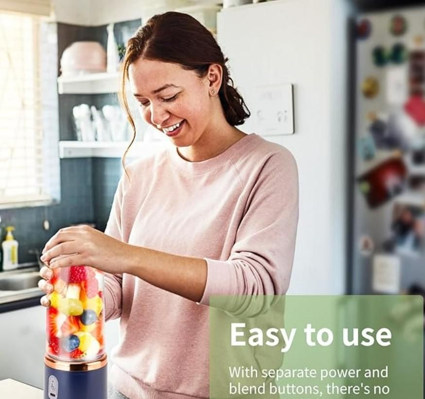 Person using small portable juicer making fresh fruit smoothie